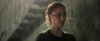 Movie still from “Annihilation” (2018), directed by Alex Garland – A woman with blood all over her face and neck; Close Up shot, Over the shoulder angle
