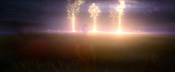 Movie still from “Annihilation” (2018), directed by Alex Garland – A man standing in a field with fireworks in the background; Extreme Wide shot, Over the shoulder angle