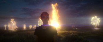 Movie still from “Annihilation” (2018), directed by Alex Garland – A woman standing in front of the sun with smoke coming out of it; Medium shot, Low angle