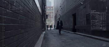 Movie still from “Anon” (2018), directed by Andrew Niccol – A group of people walking down a street; Extreme Wide shot, High angle