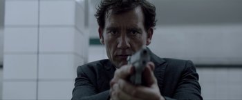 Movie still from “Anon” (2018), directed by Andrew Niccol – A person holding a gun; Close Up shot, Low angle