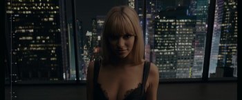 Movie still from “Anon” (2018), directed by Andrew Niccol – A woman in a black bra is standing in front of a window; Close Up shot, High angle