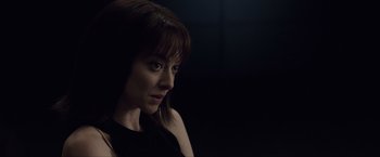 Movie still from “Anon” (2018), directed by Andrew Niccol – A person wearing a black shirt; Close Up shot, Over the shoulder angle