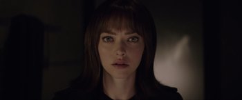 Movie still from “Anon” (2018), directed by Andrew Niccol – A woman's face in a dark room; Close Up shot, Over the shoulder angle