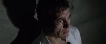 Movie still from “Anon” (2018), directed by Andrew Niccol – A person looking down at his face; Close Up shot, Low angle