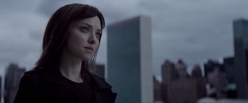 Movie still from “Anon” (2018), directed by Andrew Niccol – A person with a building in the background; Close Up shot, Over the shoulder angle