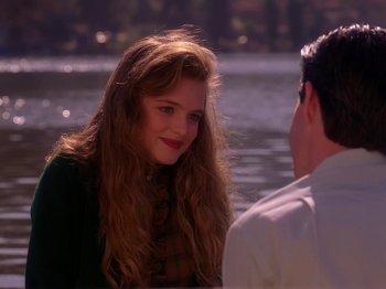 Movie still from “Twin Peaks” (1990), created by David Lynch – A young woman sitting next to a man on a boat; Close Up shot, Over the shoulder angle