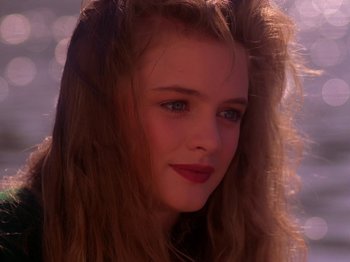 Movie still from “Twin Peaks” (1990), created by David Lynch – A person with long hair; Close Up shot, Over the shoulder angle