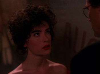 Movie still from “Twin Peaks” (1990), created by David Lynch – A person wearing a red dress; Close Up shot, Over the shoulder angle