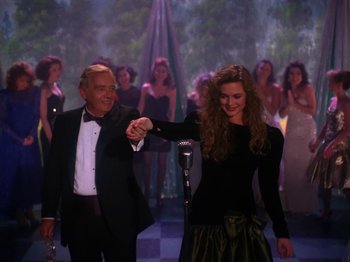 Movie still from “Twin Peaks” (1990), created by David Lynch – A man and a woman shaking hands in front of a microphone; Medium shot, High angle