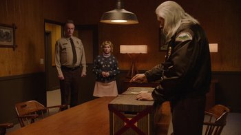 Movie still from “Twin Peaks” (2017), directed by David Lynch – A man and a woman standing in front of a table; Medium shot, Over the shoulder angle