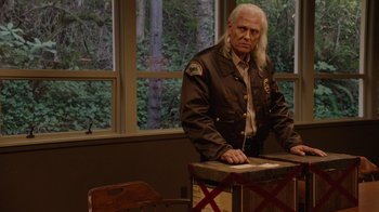 Movie still from “Twin Peaks” (2017), directed by David Lynch – An older man standing in front of a window; Medium shot, Over the shoulder angle