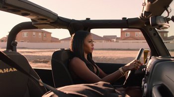 Movie still from “Twin Peaks” (2017), directed by David Lynch – A woman sitting in the driver's seat of a car; Medium shot, Over the shoulder angle