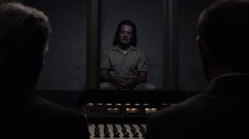 Movie still from “Twin Peaks” (2017), directed by David Lynch – A man sitting in a chair in front of a sound board; Medium shot, Over the shoulder angle