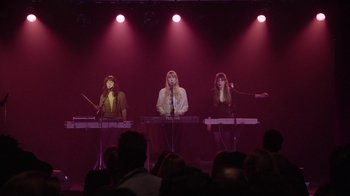 Movie still from “Twin Peaks” (2017), directed by David Lynch – A group of women playing keyboards on a stage; Wide shot, Low angle