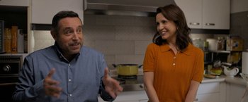 Movie still from “Anonymously Yours” (2021), directed by Maria Torres – A man and a woman are talking in a kitchen; Medium shot, Over the shoulder angle