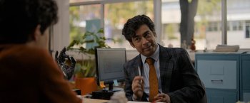 Movie still from “Anonymously Yours” (2021), directed by Maria Torres – A man sitting at a desk in front of a computer; Medium shot, Over the shoulder angle