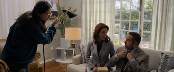 Movie still from “Anonymously Yours” (2021), directed by Maria Torres – A woman sitting on a couch next to a man; Medium shot, Over the shoulder angle