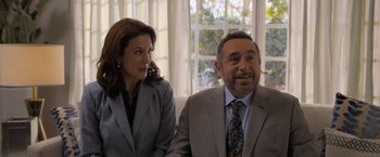 Movie still from “Anonymously Yours” (2021), directed by Maria Torres – A man and a woman sitting next to each other in front of a window; Medium shot, Over the shoulder angle