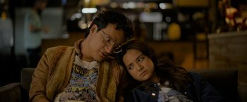 Movie still from “Anonymously Yours” (2021), directed by Maria Torres – A man and a woman sitting next to each other; Medium shot, Over the shoulder angle
