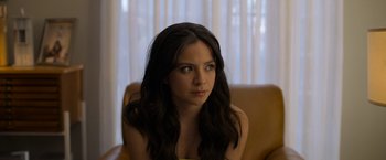 Movie still from “Anonymously Yours” (2021), directed by Maria Torres – A beautiful young lady sitting in a chair; Close Up shot, Low angle