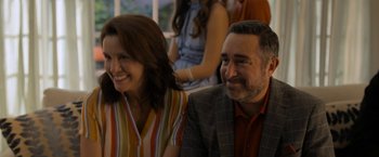 Movie still from “Anonymously Yours” (2021), directed by Maria Torres – A man and a woman sitting next to each other; Close Up shot, Over the shoulder angle