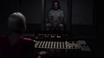 Movie still from “Twin Peaks” (2017), directed by David Lynch – A man sitting in front of a sound board in a room; Medium shot, Over the shoulder angle