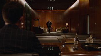Movie still from “Twin Peaks” (2017), directed by David Lynch – A man in a suit standing in an empty room; Wide shot, Over the shoulder angle