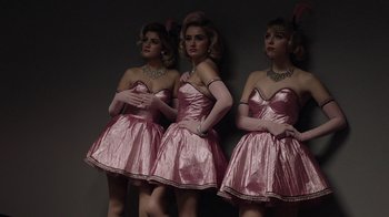 Movie still from “Twin Peaks” (2017), directed by David Lynch – A group of three women in pink dresses standing next to each other; Medium shot, Low angle