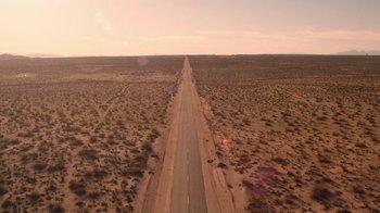 Movie still from “Twin Peaks” (2017), directed by David Lynch – An aerial view of an empty road in the middle of the desert; Extreme Wide shot, High angle