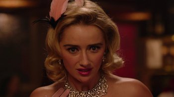 Movie still from “Twin Peaks” (2017), directed by David Lynch – A woman with a pink feather in her hair; Close Up shot, Over the shoulder angle