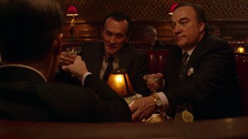 Movie still from “Twin Peaks” (2017), directed by David Lynch – A group of men sitting at a table with drinks; Medium shot, High angle