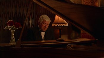 Movie still from “Twin Peaks” (2017), directed by David Lynch – A man in a tuxedo sitting at a piano; Medium shot, Over the shoulder angle