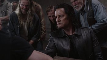 Movie still from “Twin Peaks” (2017), directed by David Lynch – A group of men standing around a table; Medium shot, Over the shoulder angle
