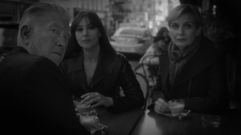 Movie still from “Twin Peaks” (2017), directed by David Lynch – A group of people sitting at a table with drinks; Medium shot, Over the shoulder angle