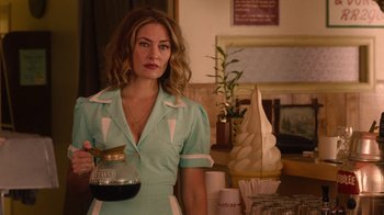 Movie still from “Twin Peaks” (2017), directed by David Lynch – A woman holding a jar of coffee in her hand; Medium shot, Over the shoulder angle