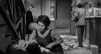 Movie still from “Two Women” (1960), directed by Vittorio De Sica – A woman holding a baby in her arms in an old photo; Medium shot, Low angle