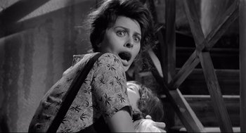 Movie still from “Two Women” (1960), directed by Vittorio De Sica – A woman holding a baby in her arms and making a funny face; Medium shot, Low angle