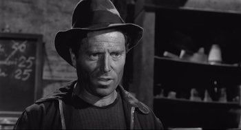 Movie still from “Two Women” (1960), directed by Vittorio De Sica – A man wearing a hat and a sweater; Close Up shot, Low angle