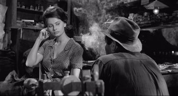 Movie still from “Two Women” (1960), directed by Vittorio De Sica – A woman sitting next to a man smoking a cigarette; Medium shot, Over the shoulder angle