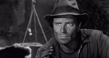 Movie still from “Two Women” (1960), directed by Vittorio De Sica – A black and white photo of a man in a hat; Close Up shot, Low angle