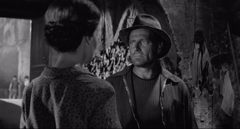 Movie still from “Two Women” (1960), directed by Vittorio De Sica – A man and a woman are standing in front of each other; Medium shot, Over the shoulder angle