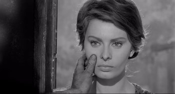 Movie still from “Two Women” (1960), directed by Vittorio De Sica – A black - and - white photo of a person touching a woman's face; Close Up shot, Over the shoulder angle