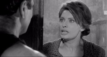 Movie still from “Two Women” (1960), directed by Vittorio De Sica – A black - and - white photo of a woman looking at herself in the mirror; Close Up shot, Over the shoulder angle