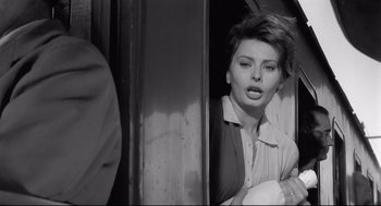 Movie still from “Two Women” (1960), directed by Vittorio De Sica – A black - and - white photo of a woman leaning against a wall; Close Up shot, Over the shoulder angle