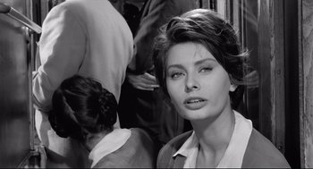 Movie still from “Two Women” (1960), directed by Vittorio De Sica – A black - and - white photo of a woman in a suit; Close Up shot, Over the shoulder angle