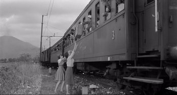 Movie still from “Two Women” (1960), directed by Vittorio De Sica – A black and white photo of two women reaching out of a train; Wide shot, Low angle