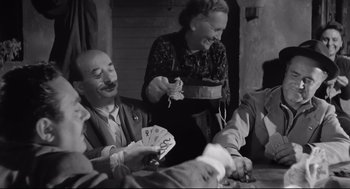Movie still from “Two Women” (1960), directed by Vittorio De Sica – An old black and white photo of people playing cards; Medium shot, High angle