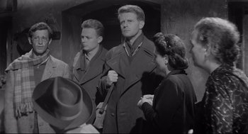 Movie still from “Two Women” (1960), directed by Vittorio De Sica – A group of men and women standing next to each other; Medium shot, Low angle