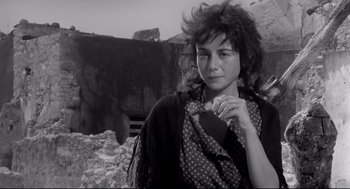Movie still from “Two Women” (1960), directed by Vittorio De Sica – A black and white photo of a woman in a scarf; Close Up shot, Low angle